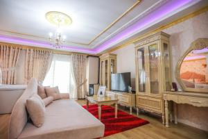 a living room with a couch and a tv at Luxurious Apartment Lake View Pogradec in Pogradec