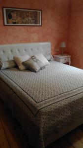 a bedroom with a large bed with a white headboard at Alloggio Castello Tesino in Castello Tesino