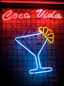 a neon sign with a drink in a martini glass at Alona Vida Beach Resort in Panglao Island