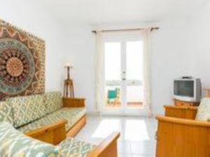 a living room with a couch and a tv at Duplex Son Parc Vistas Costa Norte in Es Mercadal