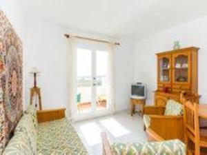 a living room with a couch and a window at Duplex Son Parc Vistas Costa Norte in Es Mercadal
