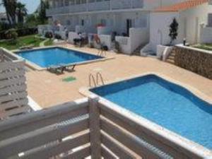 two swimming pools on top of a building at Duplex Son Parc Vistas Costa Norte in Es Mercadal +12 photos