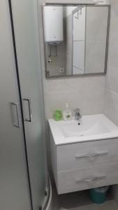 a white bathroom with a sink and a mirror at Apartment Iva in Rovinj +35 photos