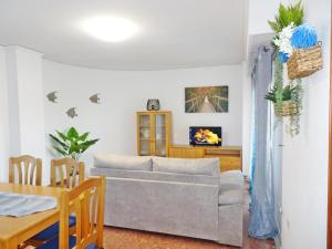 a living room with a couch and a table at ROMA XII - Apartamento Familiar in Playa de Gandia