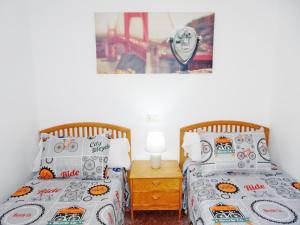 two twin beds in a bedroom with a toy at ROMA XII - Apartamento Familiar in Playa de Gandia +45 photos
