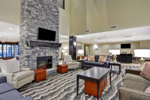 a living room with a fireplace and couches at Staybridge Suites Mt Juliet - Nashville Area in Mount Juliet