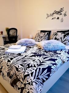 a bed with blue and white pillows on it at Diamond Apartments in Bucharest