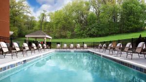 a swimming pool with chairs and a gazebo at Candlewood Suites Carrollton, an IHG Hotel in Carrollton