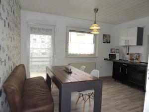 a kitchen and dining room with a table and chairs at Gästehaus Holiday in Witten