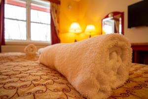 a towel on a bed in a hotel room at Tysfjord Hotel in Storjord I Tysfjord