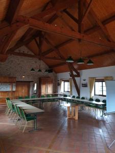 a large room with tables and green chairs at Brit Hotel Dak Hotel in Avallon