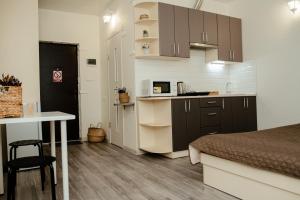 a kitchen and a bedroom with a bed and a table at Historical center "Apartments on Kontorskaya" in Kharkiv