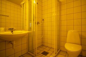 a bathroom with a shower and a toilet and a sink at Tysfjord Hotel in Storjord I Tysfjord