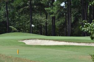 a golf course with a green with a bunker at Brunswick Plantation Resort and Golf Condo 805M with Full Kitchen in Calabash