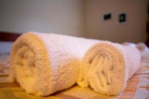 a towel shaped like a house on a bed at Tysfjord Hotel in Storjord I Tysfjord