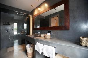 a bathroom with a sink and a mirror at Casa Nostra Boutique Hotel & Spa in Palermo
