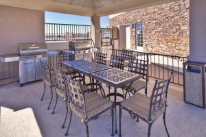 a patio with a table and chairs on a balcony at Candlewood Suites Fort Stockton by IHG in Fort Stockton