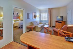 a hotel room with a bed and a living room at Candlewood Suites Fort Stockton, an IHG Hotel in Fort Stockton