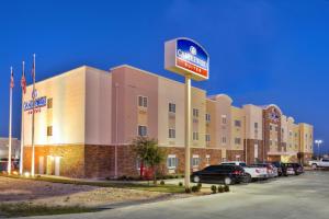 a hotel with a sign in front of a parking lot at Candlewood Suites Fort Stockton, an IHG Hotel in Fort Stockton