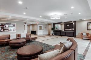 a large lobby with couches and chairs and a table at Candlewood Suites - Brighton, an IHG Hotel in Brighton