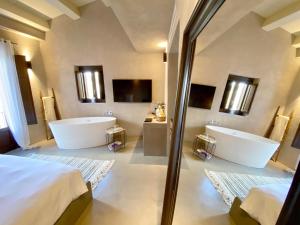 a bathroom with two sinks and two tubs at Casa Nostra Boutique Hotel & Spa in Palermo