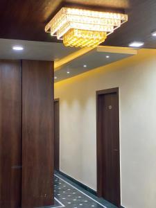 a hallway with a chandelier in a building at Shivam Hotels in Kolkata