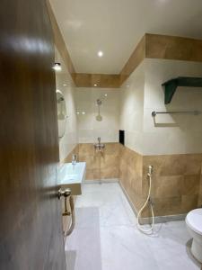 a bathroom with a sink and a toilet at Shivam Hotels in Kolkata