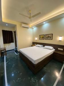 a bedroom with a bed and a ceiling at Shivam Hotels in Kolkata