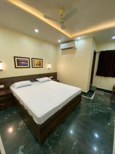 a bedroom with a large bed in a room at Shivam Hotels in Kolkata