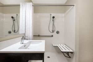 a bathroom with a sink and a shower at Candlewood Suites Durham - RTP by IHG in Durham +31 photos