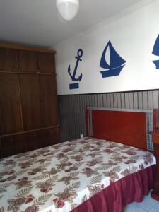 a bedroom with a bed with an anchor on the wall at Apartamento na praia do Itarare in São Vicente