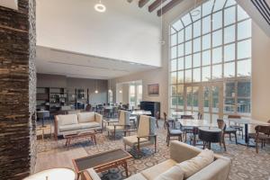 a lobby with couches and tables and windows at Staybridge Suites Silao, an IHG Hotel in Silao