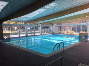 a large swimming pool in a large building at le refuge des Marmottes in Saint-Laurent-du-Jura