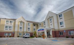 a hotel with a van parked in front of it at Candlewood Suites Fargo-North Dakota State University by IHG in Fargo