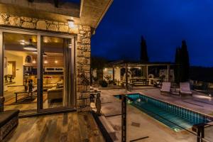 a house with a swimming pool at night at Ayia Marina in Kathikas +67 photos