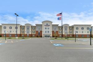 an empty parking lot in front of a building at Candlewood Suites Elmira Horseheads by IHG in Horseheads