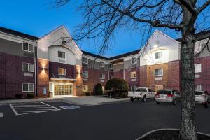 a parking lot in front of a brick building at Candlewood Suites Richmond West End Short Pump, an IHG Hotel in Short Pump