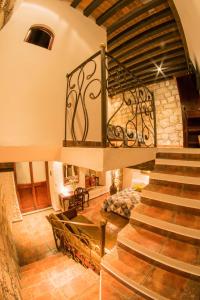 a staircase in a house with a stone wall at Hotel Mesón de los Remedios in Morelia