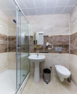 a bathroom with a sink and a shower and a toilet at River Elite Hotel Spa in Antalya +29 photos