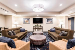 a living room with couches and a flat screen tv at Candlewood Suites Eau Claire I-94, an IHG Hotel in Eau Claire