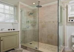 a bathroom with a shower with a glass door at The Inn at Cape Cod in Yarmouth Port