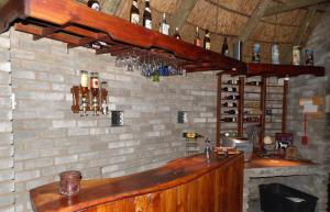 a bar in a room with a brick wall at The Hexagon Wildlife Conservation in Uitenhage