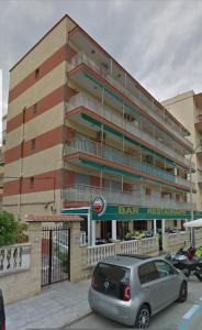 a car parked in front of a bar restaurant at Apartmento de 3 habitaciones con vistas al mar in Playa de Gandia
