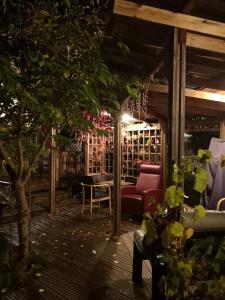 a patio with a red couch and a table at Kouvola Guest house in Kouvola