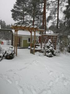 a yard covered in snow with a gazebo at Kouvola Guest house in Kouvola