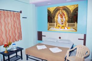 a bedroom with a bed and a large shrine at Hotel Sai Darshan in Shirdi