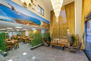 a restaurant with tables and chairs in a room at River Elite Hotel Spa in Antalya
