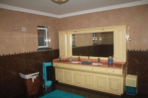 a bathroom with a sink and a mirror at Moradia da Graça Guesthouse in Praia da Vitória