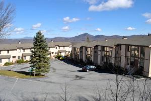 an apartment complex with a car parked in a parking lot at The Highlands at Sugar by Capital Vacations in Banner Elk