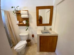a bathroom with a toilet and a sink with a mirror at MIO Cancún Hotel Boutique in Cancún +37 photos